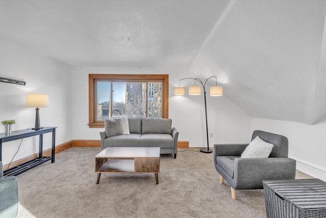 carpeted living room featuring a textured ceiling and vaulted ceiling