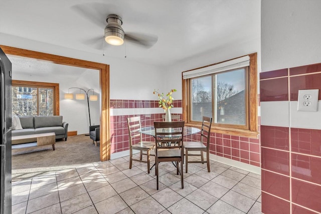 tiled dining room featuring ceiling fan and a healthy amount of sunlight