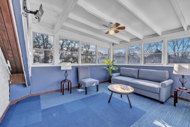 sunroom / solarium with a wealth of natural light, ceiling fan, and beamed ceiling