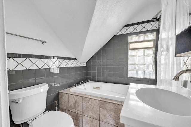 bathroom featuring sink, a textured ceiling, vaulted ceiling, tile walls, and toilet