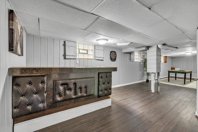 basement with bar, hardwood / wood-style floors, and a drop ceiling