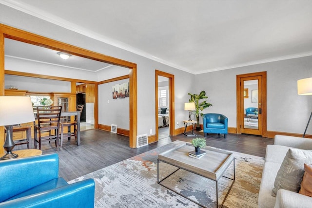 living room featuring ornamental molding and dark hardwood / wood-style floors