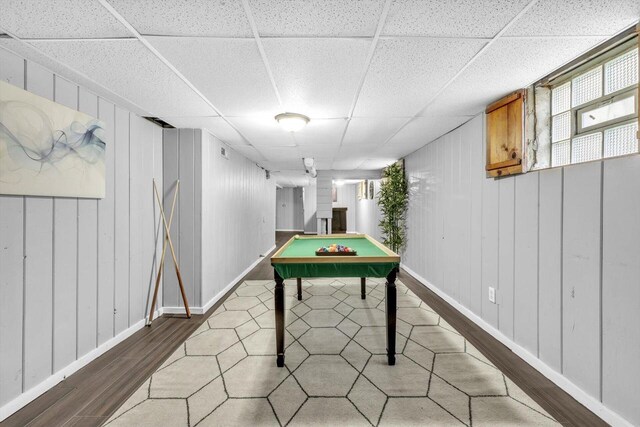 recreation room with billiards, a drop ceiling, and hardwood / wood-style flooring