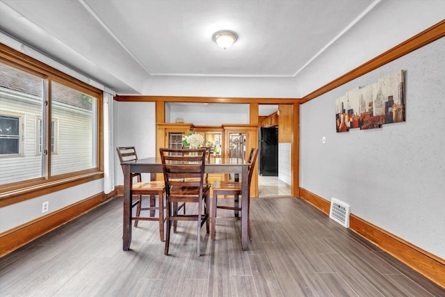 dining space with hardwood / wood-style flooring