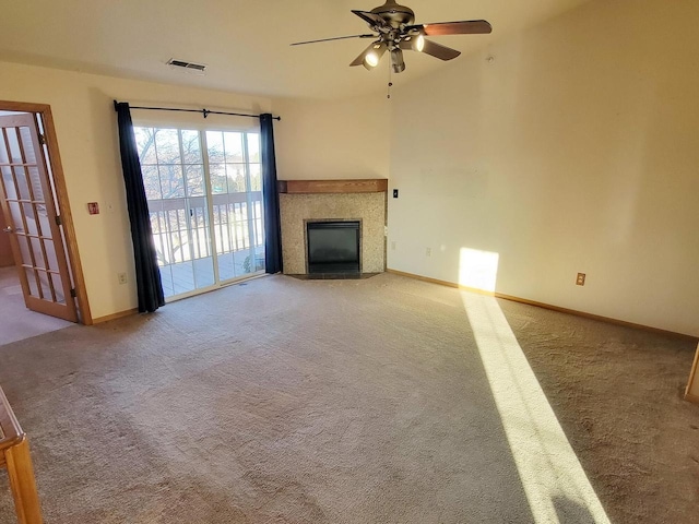 unfurnished living room with ceiling fan and carpet