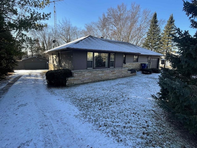 view of front of house with a garage and an outbuilding