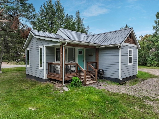 back of house with a porch and a lawn