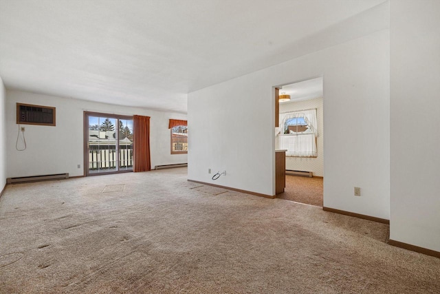 unfurnished living room with a wall unit AC, light carpet, and baseboard heating