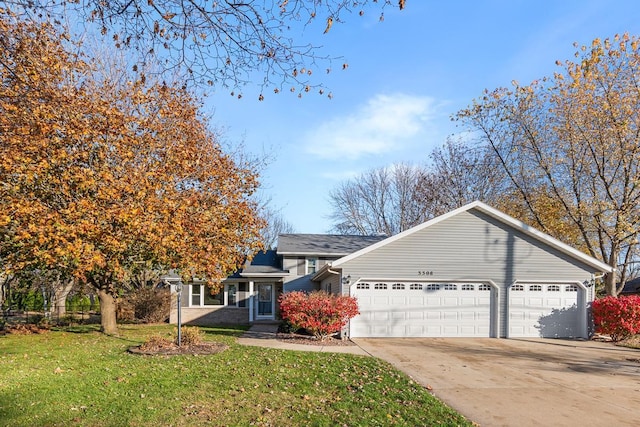 view of front of house with a front yard and a garage