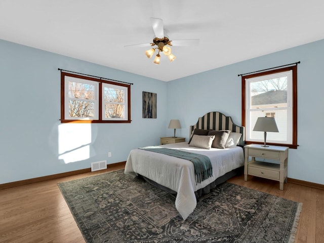 bedroom with ceiling fan and light hardwood / wood-style floors