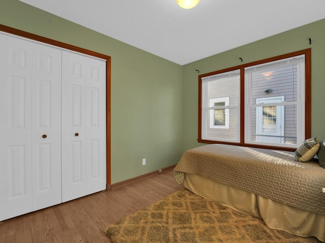 bedroom with a closet and light hardwood / wood-style flooring