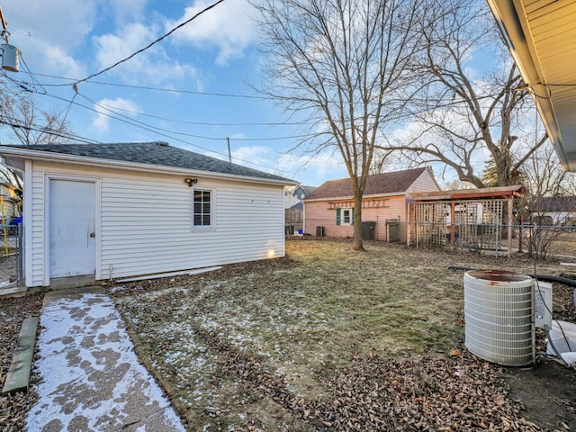 view of yard featuring an outbuilding and central air condition unit