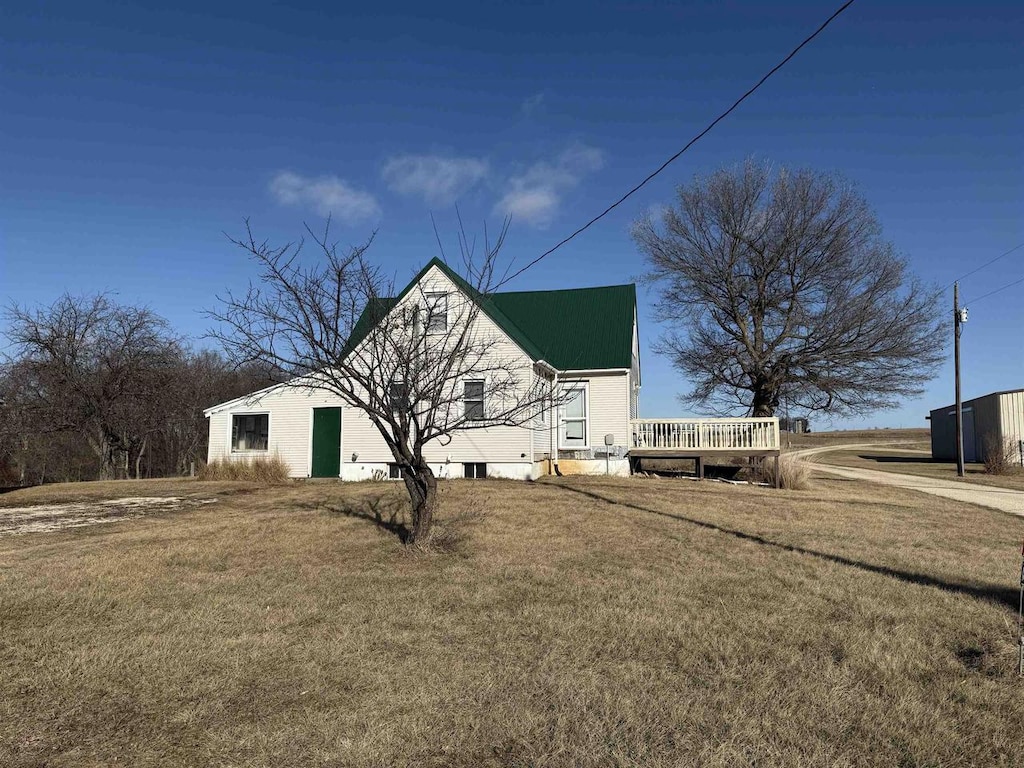 view of home's exterior with a yard and a wooden deck