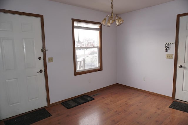 entryway featuring a notable chandelier and light wood-type flooring