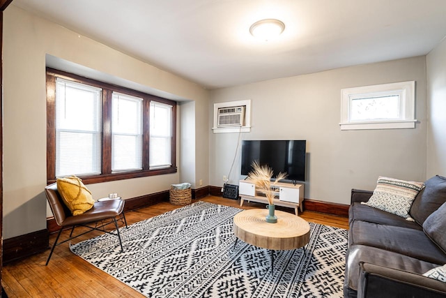 living room featuring hardwood / wood-style floors and a wall mounted AC