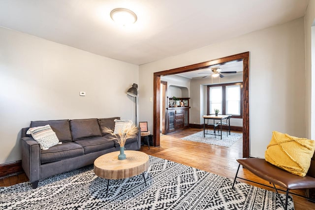 living room with ceiling fan and hardwood / wood-style floors