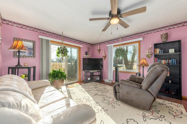 living room featuring light hardwood / wood-style floors and ceiling fan