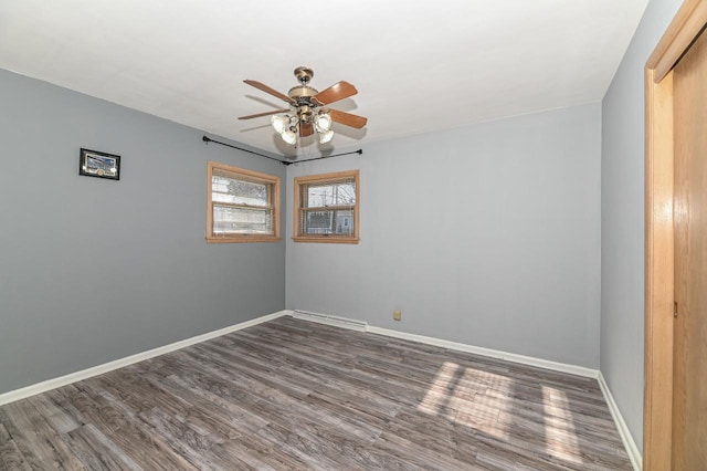 unfurnished room featuring ceiling fan and dark hardwood / wood-style floors