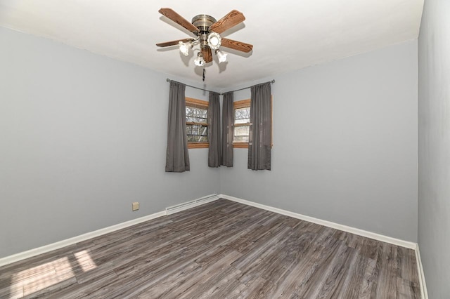 unfurnished room with ceiling fan, a baseboard radiator, and dark hardwood / wood-style floors