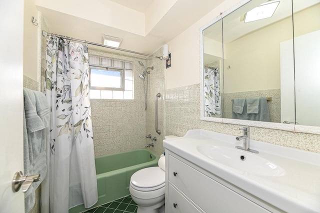 full bathroom with toilet, tile patterned flooring, tile walls, shower / bath combo, and vanity