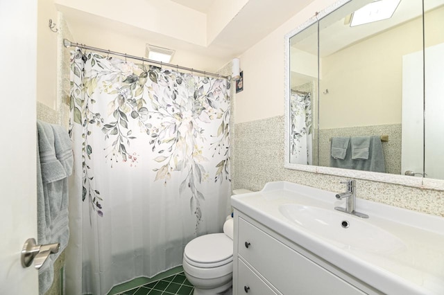 bathroom featuring toilet, tile patterned flooring, tile walls, a shower with shower curtain, and vanity