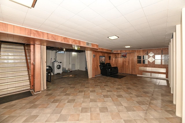 basement featuring wood walls