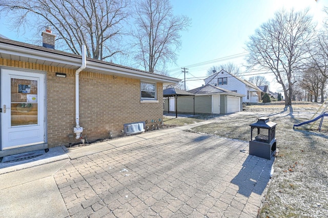 view of side of property with a garage and an outdoor structure