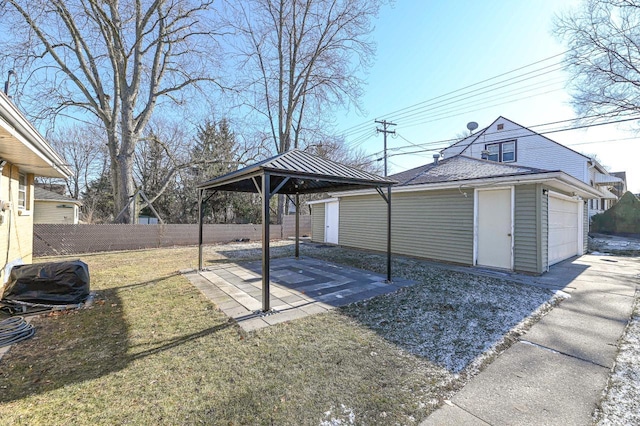 view of yard featuring a garage, an outdoor structure, and a gazebo