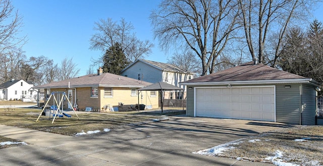 exterior space featuring a garage and an outbuilding