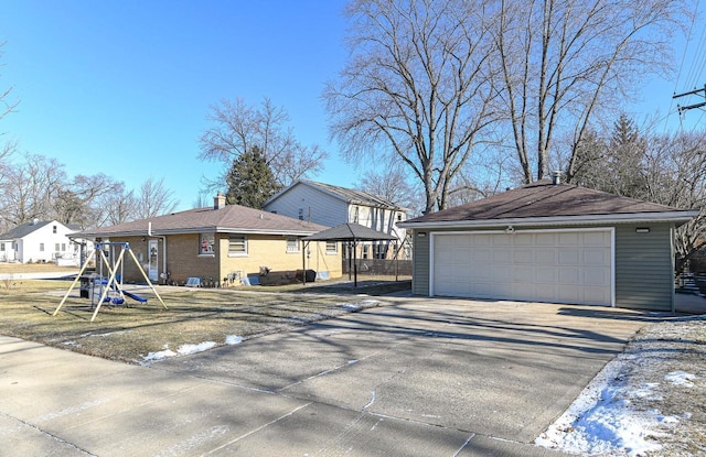 exterior space featuring a garage and an outbuilding