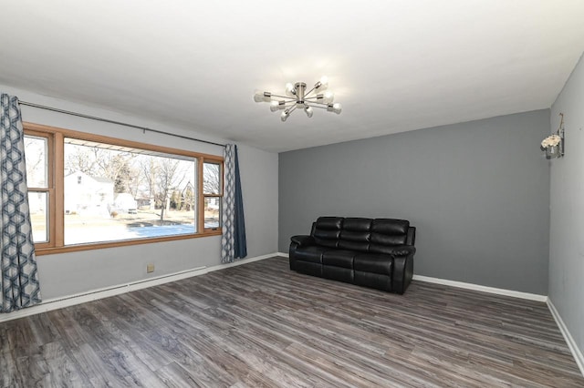 sitting room featuring a chandelier and dark hardwood / wood-style floors