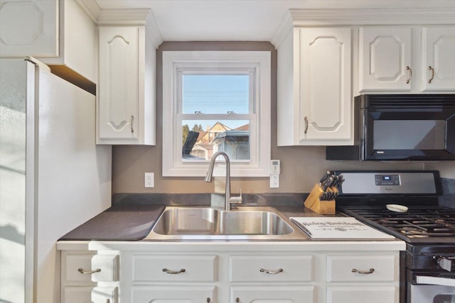 kitchen featuring sink, white cabinetry, and gas stove