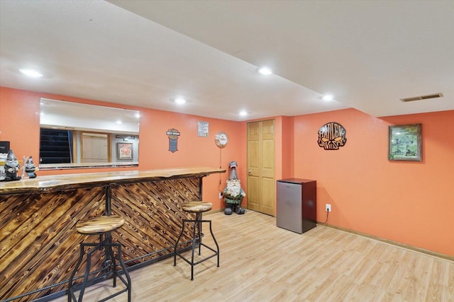 bar featuring light wood-type flooring