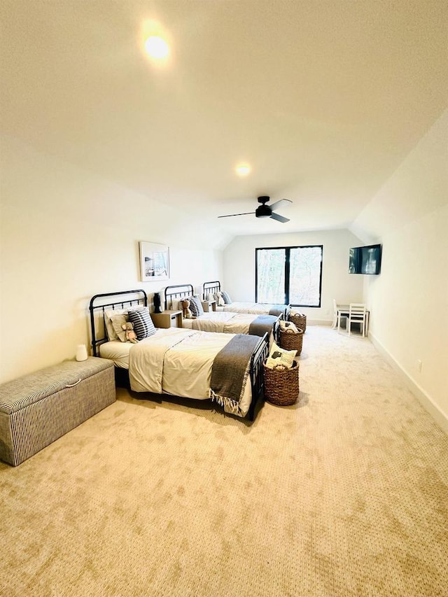 carpeted bedroom featuring lofted ceiling and ceiling fan