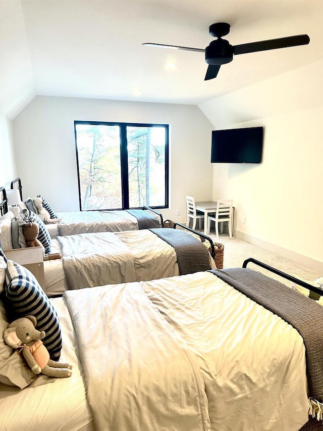 carpeted bedroom featuring ceiling fan and vaulted ceiling