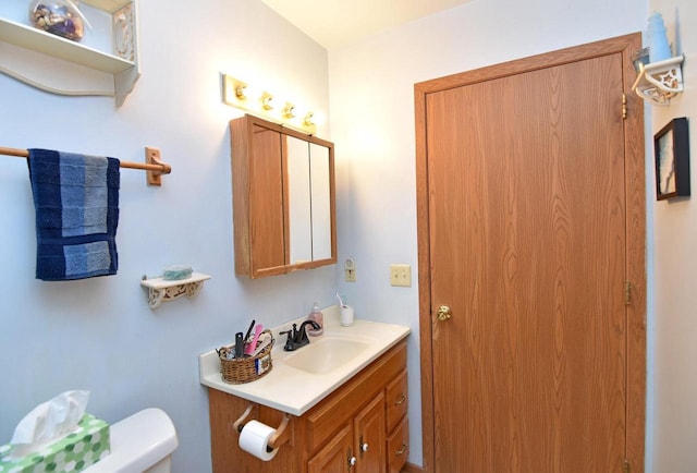 bathroom with toilet and vanity