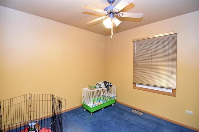 interior space with ceiling fan and carpet