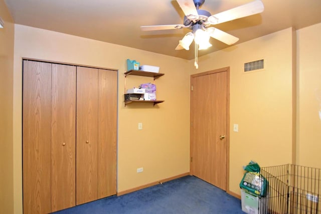 unfurnished bedroom with a closet, ceiling fan, and dark carpet