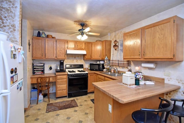 kitchen featuring white appliances, ceiling fan, sink, and kitchen peninsula