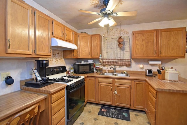 kitchen with sink, gas range, and ceiling fan