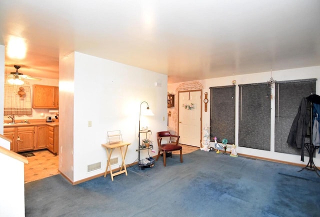 misc room featuring sink, light carpet, and ceiling fan