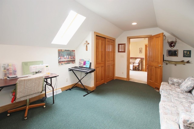 carpeted office space with vaulted ceiling with skylight