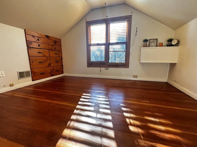 bonus room featuring vaulted ceiling and dark hardwood / wood-style flooring