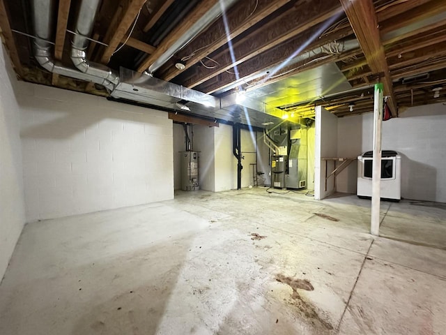 basement featuring washer / dryer, water heater, and heating unit