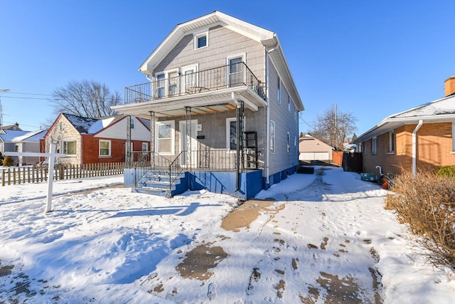 view of front of property with a balcony and covered porch