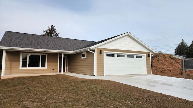 ranch-style home with a front yard and a garage