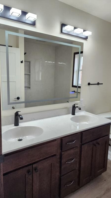 bathroom with toilet, hardwood / wood-style flooring, and vanity