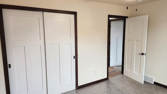 unfurnished bedroom featuring light colored carpet and a closet