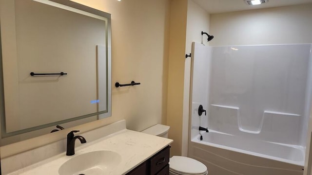 full bathroom featuring tub / shower combination, vanity, and toilet