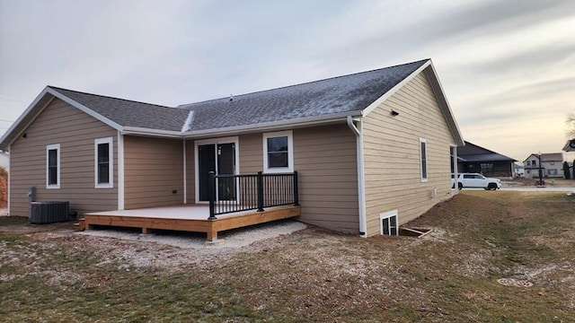 rear view of house featuring central AC and a deck